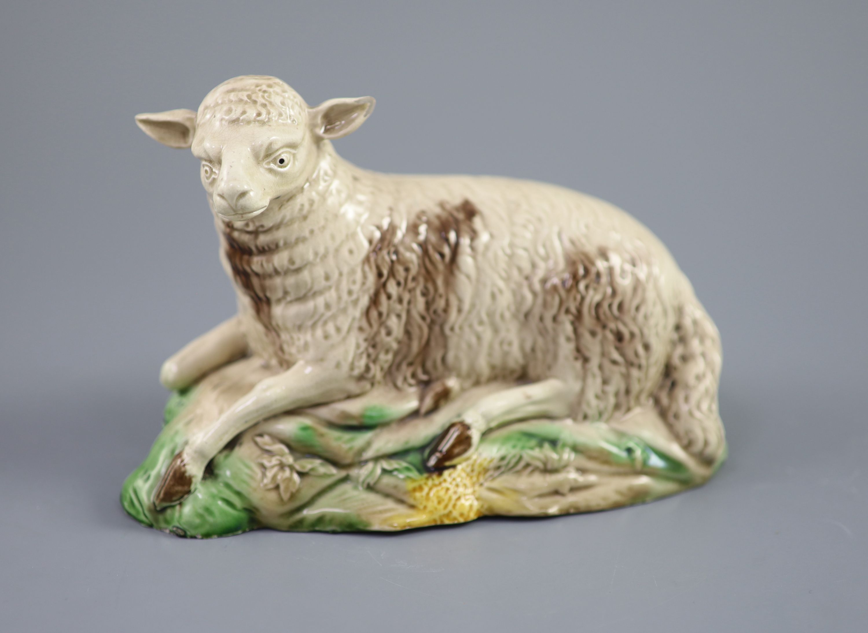 A Ralph Wood the Younger polychrome pottery figure of a recumbent ewe, c.1780-90 , length 18cm